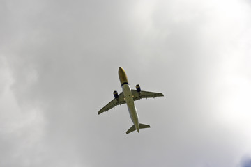 Airplane flies against a background of white cloud