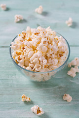 salty popcorn on turquoise wooden surface