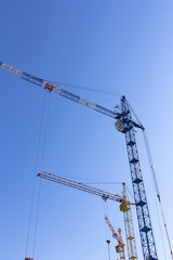 Industrial landscape, building crane against the blue sky