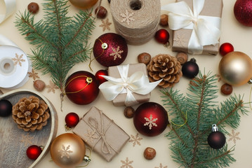 Christmas Colorful Background with Gift Boxes. Eco Style. Red Balls. Flat lay . Fir Branches, Pinecones.