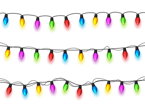 Christmas Glowing Lights On White Background. Garlands With Colored Bulbs. Xmas Holidays. Christmas Greeting Card Design Element. New Year,winter.