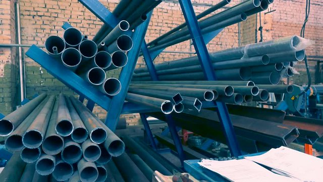 A number of new water pipes lying in the factory warehouse