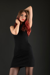 Fototapeta premium girl with long red and shiny wavy hair . Beautiful model with curly hairstyle .