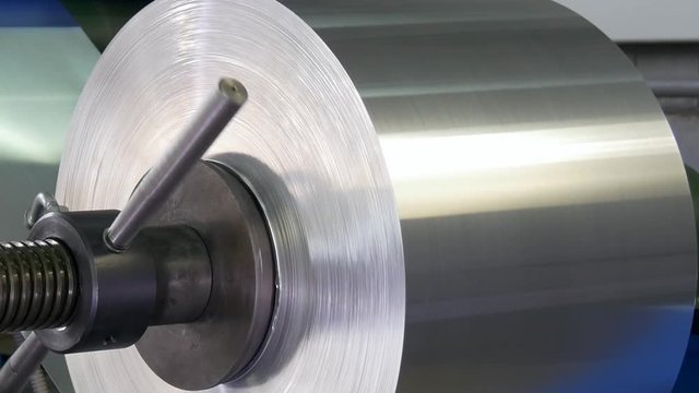 Roll of metal sheets on industrial CNC machine. Automation of work. Modern technologies.