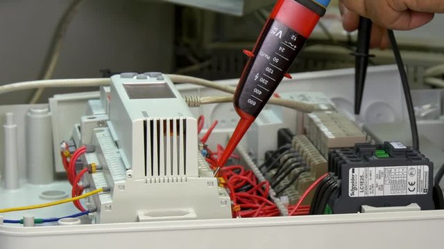 Check microcontroller control element contacts voltage indicator in factory. Handwork processes. Manufactory energy measurement accuracy technology. Computer devices.