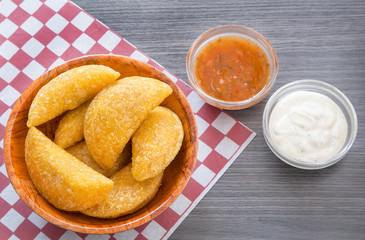 Colombian empanada with spicy sauce