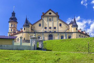 Fototapeta na wymiar Famous Tourist Destinations. Renowned Nesvizh Castle on The Hill as a Profound Example of Medieval Ages Heritage and Residence of the Radziwill Family.