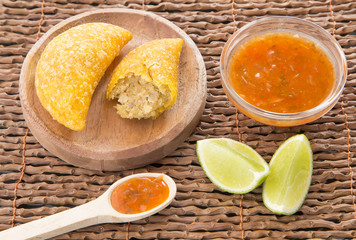 Colombian empanada with spicy sauce
