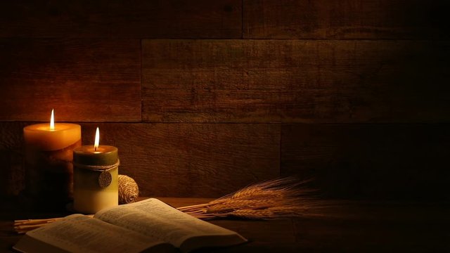 This is a close-up video symbolizing Thanksgiving, fall, autumn, using a Bible setting inside a barn background made up of old red wood.There's a lot of space for a copy In this video. 