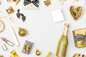 Flat Lay Christmas or Party Background with Gift boxes, pineapple, Champagne bottle, Bows, Decorations and in Gold colors. Flat lay, top view