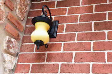 Retro style light bulb lamp on orange background,