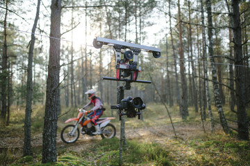 Fototapeta na wymiar Enduro journey with dirt bike high in the mountains cablecam shooting