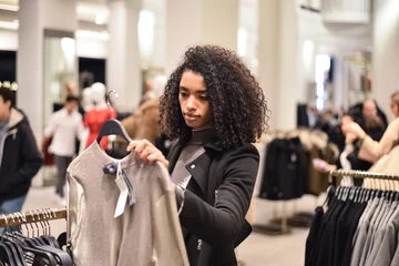 Foto op Aluminium Black young woman doing shopping in a store © DavidPrado