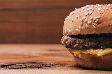 Close up of a delicious hamburger on wooden background