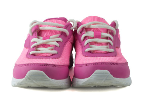 Womens pink sneakers with white laces isolated on white background. Front view.