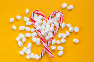 Valentine's day greeting card. Christmas apportion the top view, heart of red candy lollipop with marshmallows.