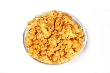 A bowl of sweet caramel popcorn isolated on white 
