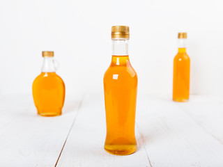 Several glass bottles with homemade orange syrup