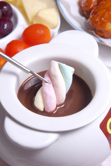 Marshmallow dipped in delicious melted chocolate fondue.