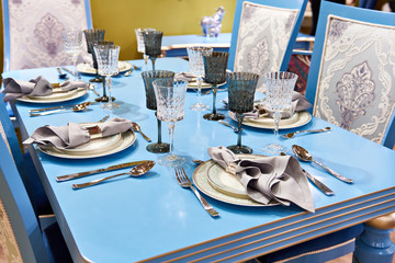 Dining napkin in metal holder in plate on festive table