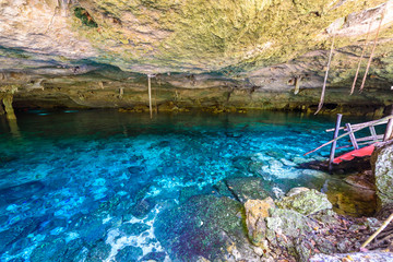 Cenote Dos Ojos in Quintana Roo, Mexico. People swimming and snorkeling in clear water. This cenote is located close to Tulum in Yucatan peninsula, Mexico.