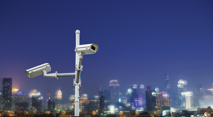 Security camera watching city at night, Protection concept