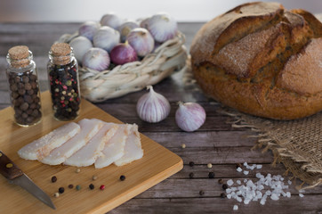 Homemade salted pork lard with bread, garlic and pepper according to Ukrainian traditions