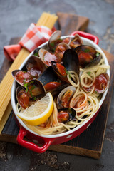 Spaghetti with vongole clams and mussels served in a bowl, selective focus