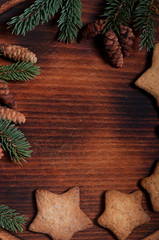 Composition of New Year's biscuits and fir branches on a wooden background, Christmas background. Christmas cookies.