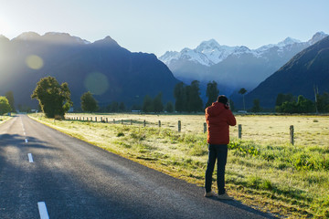 man take photograph of Mount Cook New Zealand in the morning