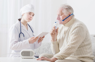 doctor does inhalation elderly man