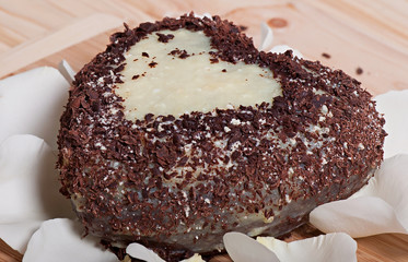 Chocolate baked in the shape of heart and beautiful light rose flower. Valentine's Day.