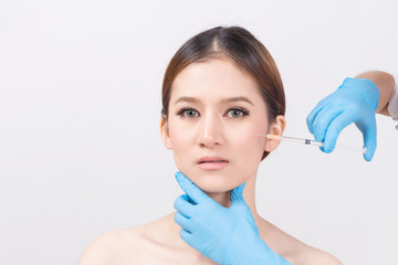 Beauty treatment concept : Female Doctors hands in gloves making an injection in face.