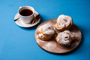 Delicious puff pastry eclair with powdered sugar