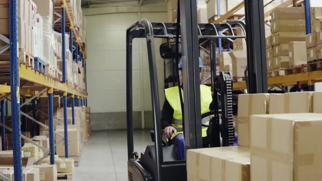 Male warehouse worker with forklift.