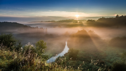 Fototapeta premium Amazing sunrise at foggy valley in autumn, Europe