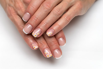 French manicure with painted daisies on small square nails