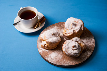 Delicious puff pastry eclair with powdered sugar