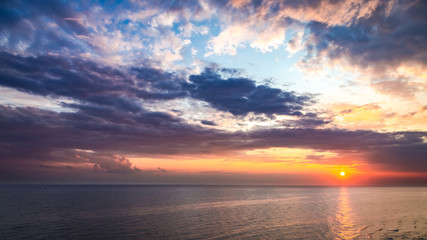Wonderful sunset over calm sea in summer with sun beam