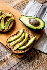 making sandwiches with avocado healthy organic food top view