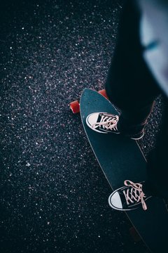 Close-up of man standing on his longboard