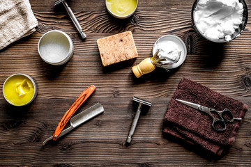 babrer workplace with tools on wooden background top view