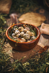Quail eggs in wooden bowl