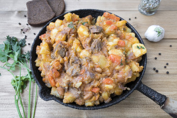 stewed vegetables with beans and meat in a frying pan