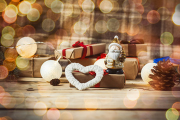 Beautiful composition. Heart, garland and gifts on a wooden background. Bokeh
