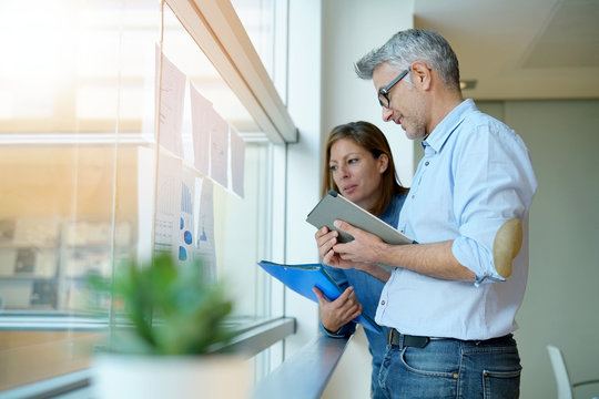 Business Team Analyzing Sales Results In Charts