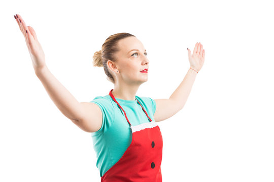 Woman wearing red apron rising lifting both hands