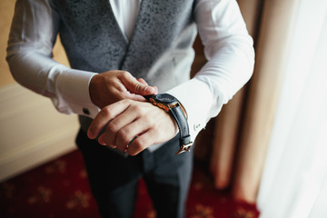 Fototapeta premium Man puts a watch on his wirst