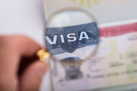 Human Hand Zooming At Visa Text