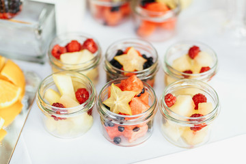 Rich table served with different kinds of fruits on different dishes